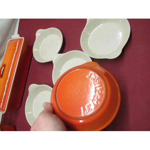 129 - Le Creuset volcanic orange rectangular lidded casserole no. 32, W34cm D11.5cm H12cm, a smaller lidde... 