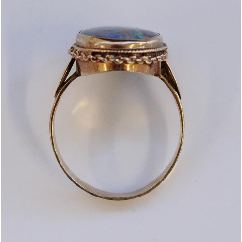 33 - 9ct yellow gold ring set with large faux opal, stamped 9ct, size P, 4.0g