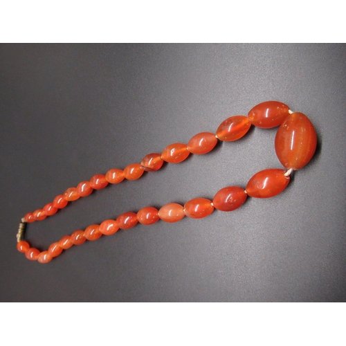 35 - Amber type necklace, single row of oval graduated beads, largest approx L2.5cm, with screw closure, ... 