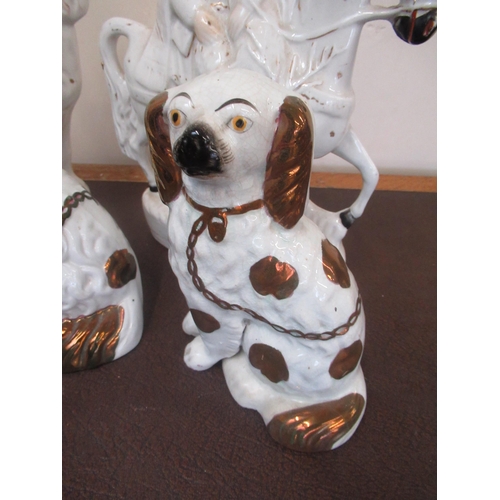 181 - Three Staffordshire type spaniels with lustre decoration, another white spaniel and figure on horseb... 