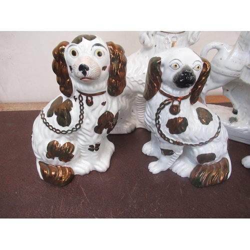 181 - Three Staffordshire type spaniels with lustre decoration, another white spaniel and figure on horseb... 