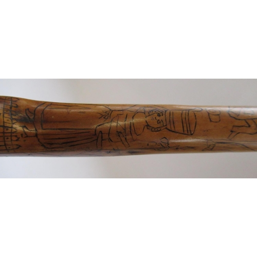 144 - Victorian naïve walking stick, handle carved as a male face with glass eyes, all over penwork decora... 