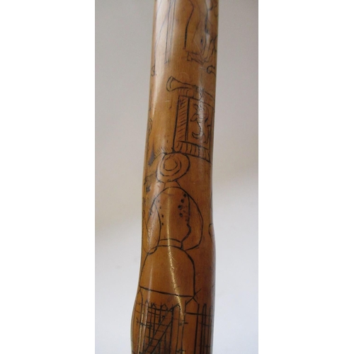 144 - Victorian naïve walking stick, handle carved as a male face with glass eyes, all over penwork decora... 