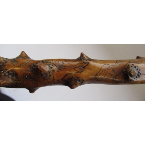 144 - Victorian naïve walking stick, handle carved as a male face with glass eyes, all over penwork decora... 