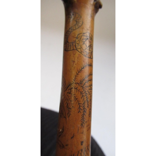 144 - Victorian naïve walking stick, handle carved as a male face with glass eyes, all over penwork decora... 