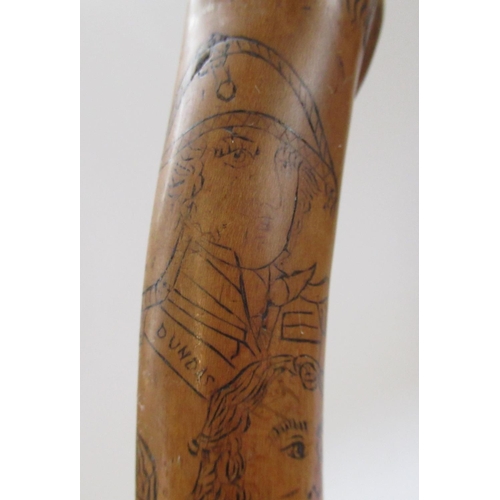 144 - Victorian naïve walking stick, handle carved as a male face with glass eyes, all over penwork decora... 