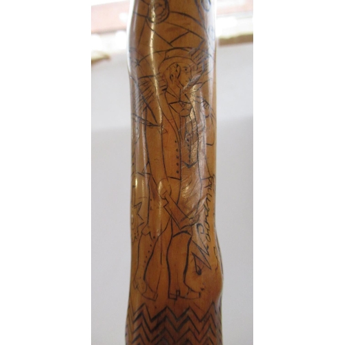 144 - Victorian naïve walking stick, handle carved as a male face with glass eyes, all over penwork decora... 