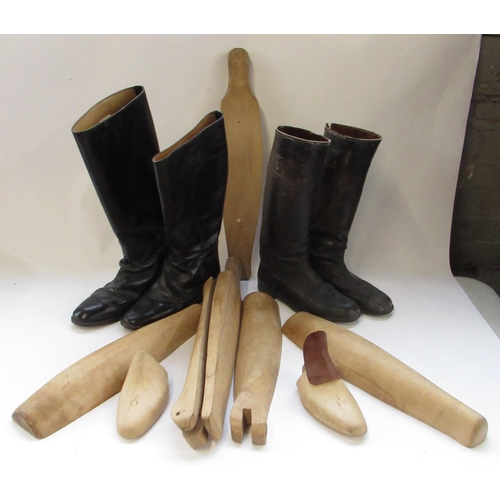 146 - Pair of black leather riding boots, size 12, a similar smaller pair and two pairs of wooden boot tre... 