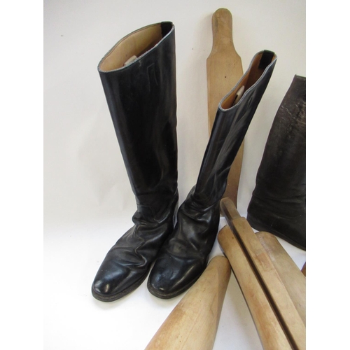 146 - Pair of black leather riding boots, size 12, a similar smaller pair and two pairs of wooden boot tre... 