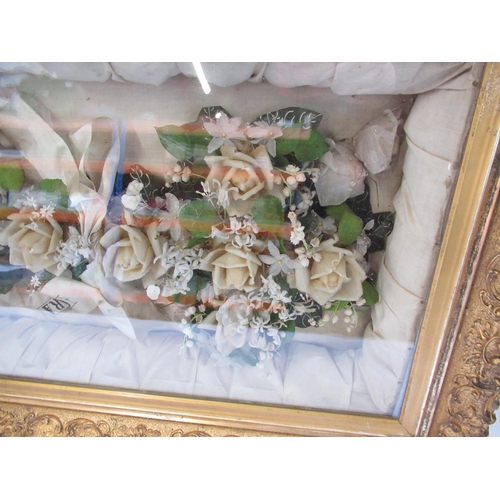 203 - C20th wax and faux flower memorial display, in glazed giltwood frame,