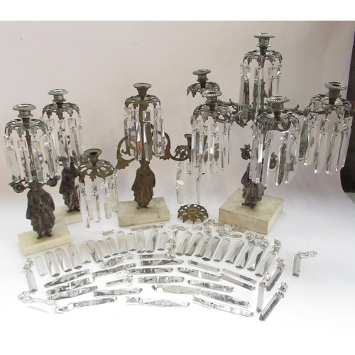 228 - Garniture of three silvered metal candelabra, figural bases with urn sconces on white marble bases, ... 