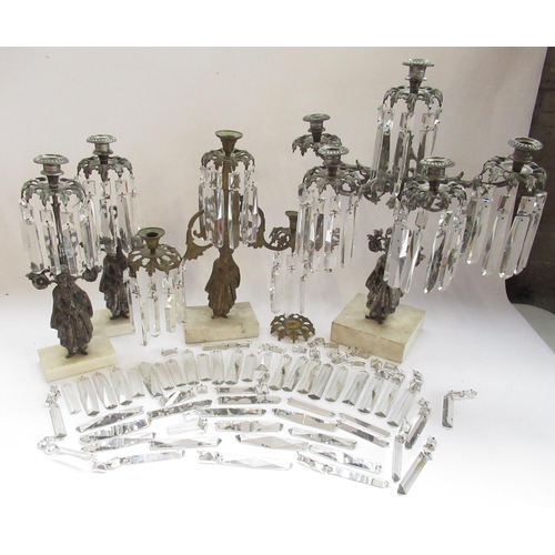 228 - Garniture of three silvered metal candelabra, figural bases with urn sconces on white marble bases, ... 