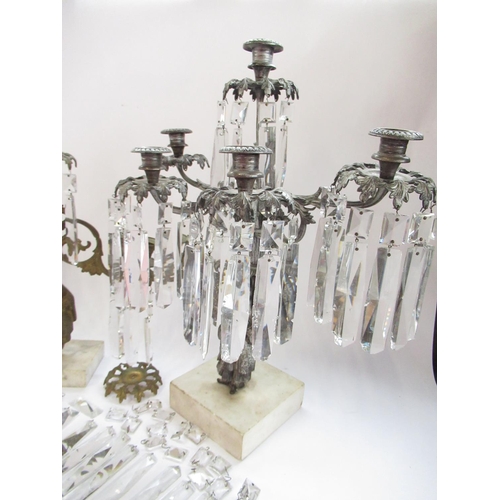 228 - Garniture of three silvered metal candelabra, figural bases with urn sconces on white marble bases, ... 