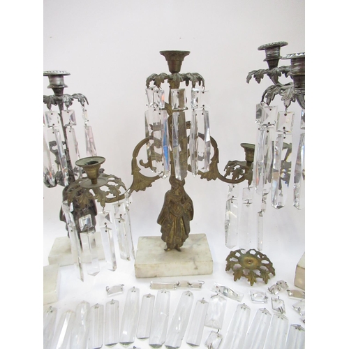 228 - Garniture of three silvered metal candelabra, figural bases with urn sconces on white marble bases, ... 