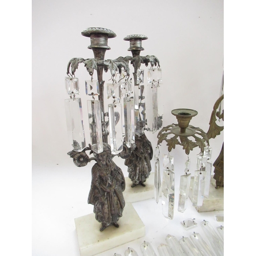 228 - Garniture of three silvered metal candelabra, figural bases with urn sconces on white marble bases, ... 