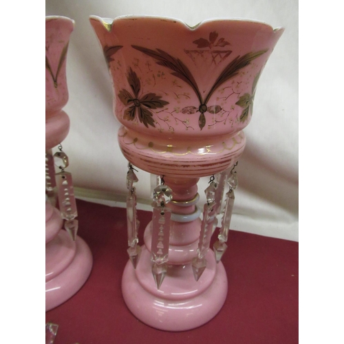 304 - Pair of late Victorian pink tinted lustres with hand painted gilt decoration, faceted clear drops on... 