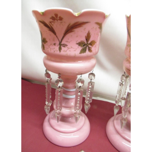 304 - Pair of late Victorian pink tinted lustres with hand painted gilt decoration, faceted clear drops on... 