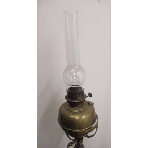 309 - C20th wrought iron and brass floor standing rise and fall oil lamp with barley twist column, over ca... 