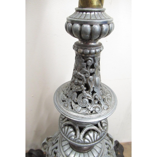 309 - C20th wrought iron and brass floor standing rise and fall oil lamp with barley twist column, over ca... 