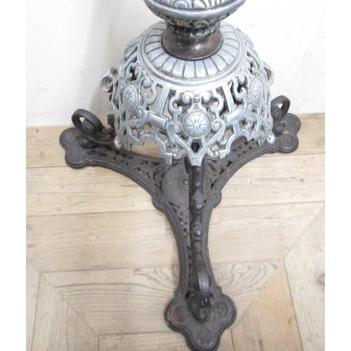 309 - C20th wrought iron and brass floor standing rise and fall oil lamp with barley twist column, over ca... 