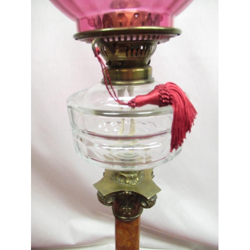 315 - Late C19th oil lamp, cranberry coloured shade, faceted clear glass reservoir on sienna marble corint... 