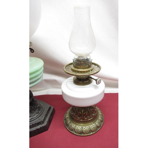 318 - Early C20th oil lamp with opaque glass shade, opaline green tinted reservoir on cast metal base, H55... 