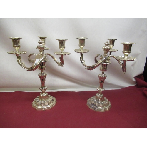 131 - Pair of C20th EPNS rococo design three branch candelabra with scrolled rustic arms, converted to ele... 