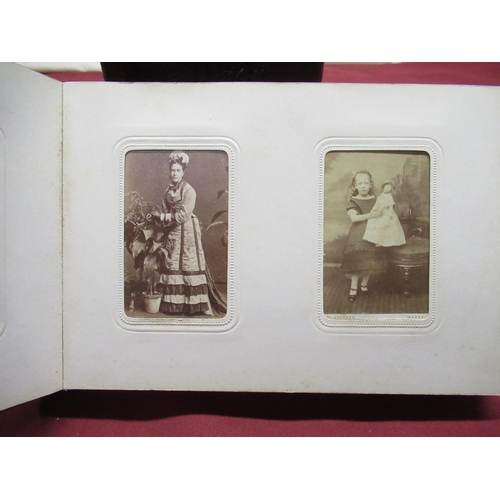 368 - Two late C19th carte de visite cabinet card albums containing portrait fashion photographs, young la... 