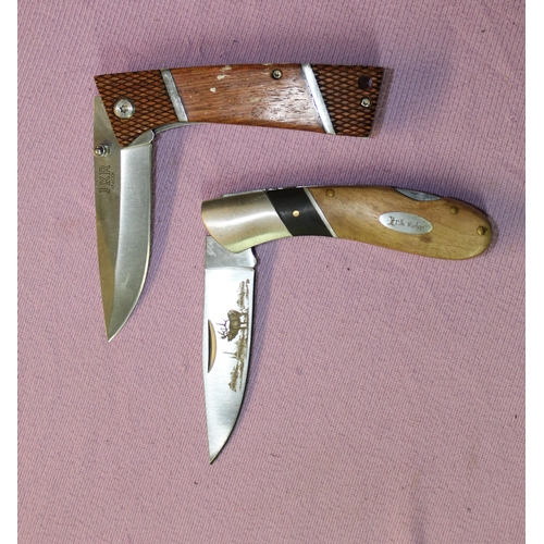 207 - 2 folding pocket knives. One by Elk Ridge (with box) with laser engraved image of a stag on the blad... 