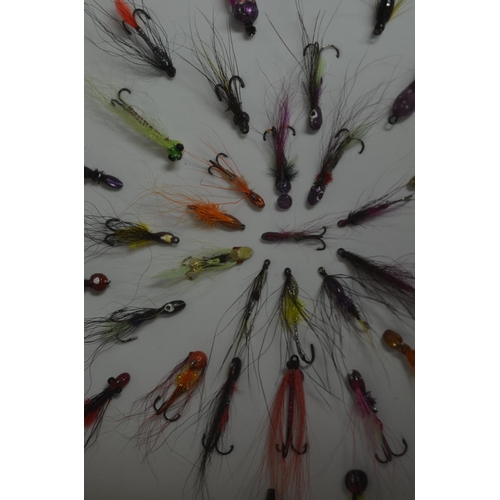 57 - Framed Salmon and Trout lures in a symmetrical pattern. Frame glass and wood. W35.5cm D3.4cm H35.5cm