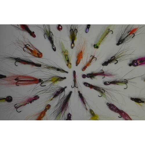 57 - Framed Salmon and Trout lures in a symmetrical pattern. Frame glass and wood. W35.5cm D3.4cm H35.5cm