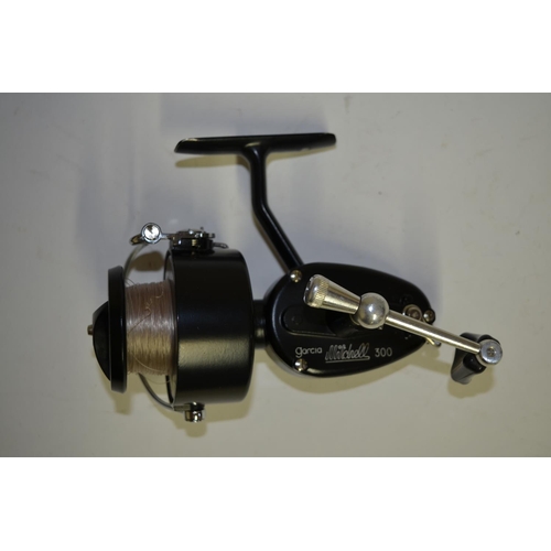 A Garcia Mitchell 300 side arm fishing reel with spare spool and brown leather  bag. Reel in excellen