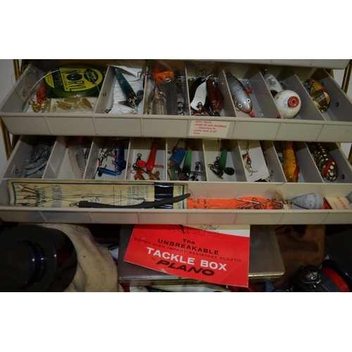 90 - A tackle box filled with lures, flies, Devon Minnows, line and accessories, a Daiwa 735 side-arm ree... 