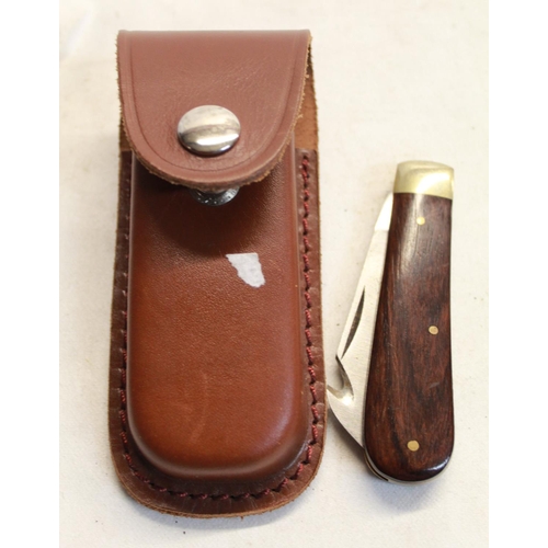 170 - Pocket knife with brown wooden handle, in leather pouch