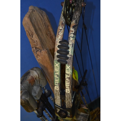 117 - A Reflex Timberwolf archery compound bow with 6 arrows (1 without pointed tip) and a scenic stand in... 