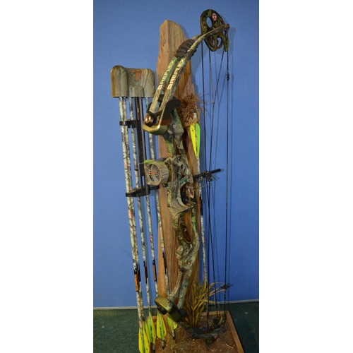 117 - A Reflex Timberwolf archery compound bow with 6 arrows (1 without pointed tip) and a scenic stand in... 