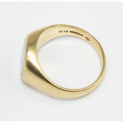 24 - 18ct yellow gold signet ring, the oval face set with a black stone, stamped 750, size R, 10.8g