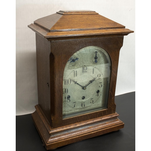 394 - Early C20th oak cased mantel clock, arched glazed door enclosing silvered and engraved arched Arabic... 