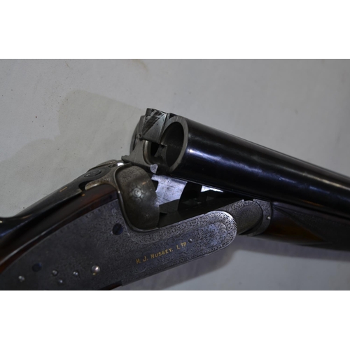 433 - A cased H.J.Hussey side lock 12 gauge side by side double barrel shot gun. Double trigger with eject... 