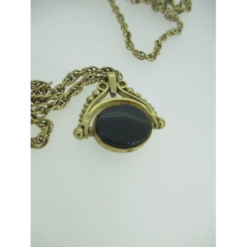45 - 9ct yellow gold revolving pendant set with bloodstone and moss agate, stamped 375, on a 9ct yellow g... 