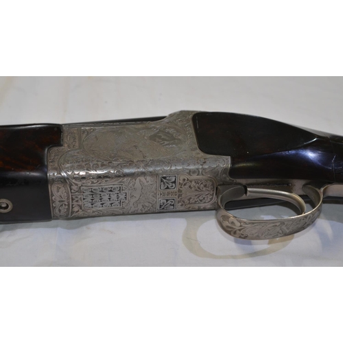 332 - A Browning 325 Grade 5 12 gauge O/U double barreled shot gun with quality engraving. Serial 31397PT.... 