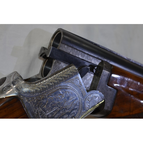 337 - A Laurona 12g O/U double barrelled shot gun. Serial No 129669. Barrell length 28'. Overall 44.5'.
Do... 