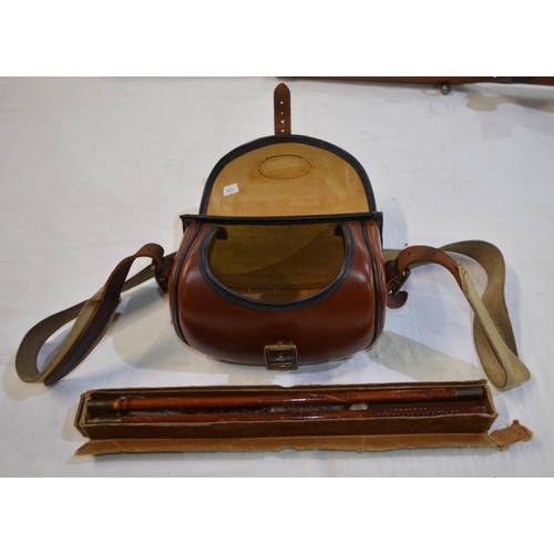 238C - A leather cartridge bag with leather and canvas shoulder strap and a boxed 12 bore cleaning kit.