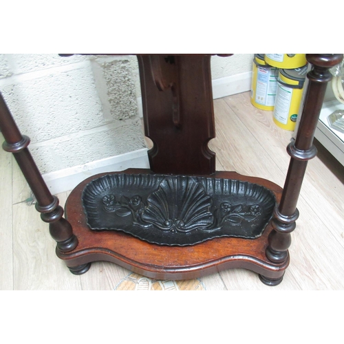 404 - Victorian mahogany hallstand, shaped back with oval mirror and eight coat pegs above a drawer, serpe... 