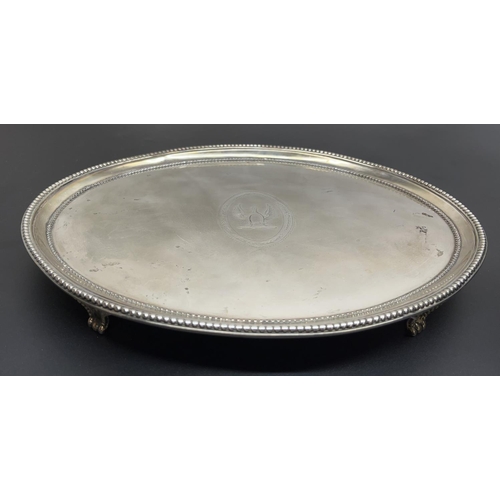 1040 - Geo.III hallmarked silver oval salver, with raised beaded border on four similar scroll feet, engrav... 