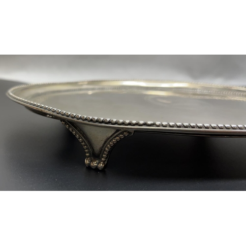 1040 - Geo.III hallmarked silver oval salver, with raised beaded border on four similar scroll feet, engrav... 