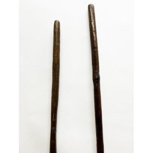 1063 - Two African carved hardwood paddles, L124cm (2)