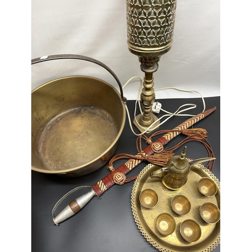 1069 - Brass jam pan with steel handle, brass table lamp, Eastern sword and an Eastern brass coffee set on ... 