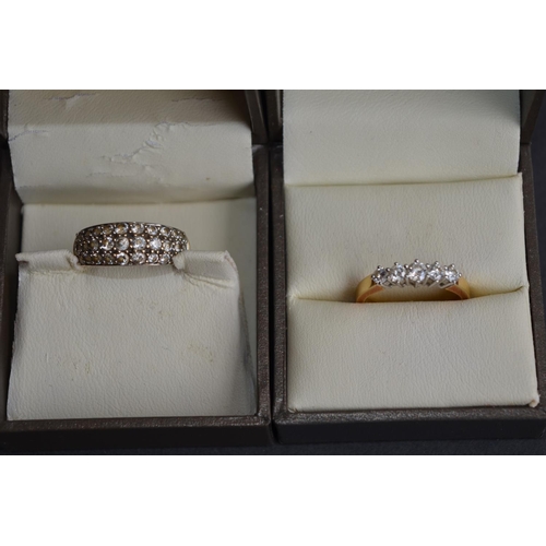 788 - 2 rings by Goldsmiths:
An 18ct yellow gold ring set with 5 brilliant cut diamonds, stamped 750, size... 