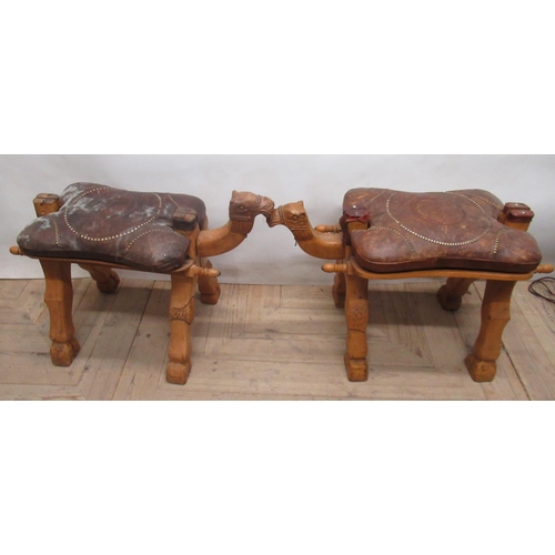 1141 - Pair of Middle Eastern Camel saddles with tooled leather seats